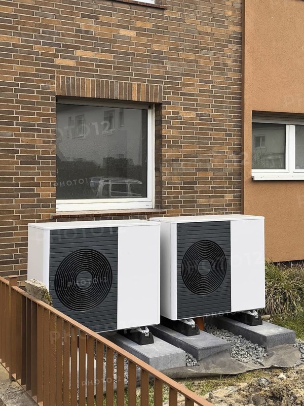 2 heat pumps are installed on an apartment block in a front garden, Hilden, Germany