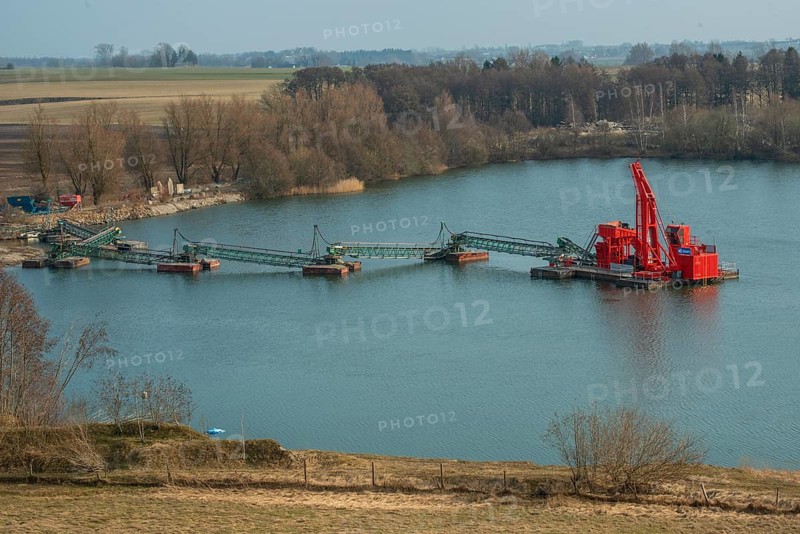 Floating excavator mining gravel below the groundwater level in Skurup municipality, Skåne county, Sweden, Scandinavia