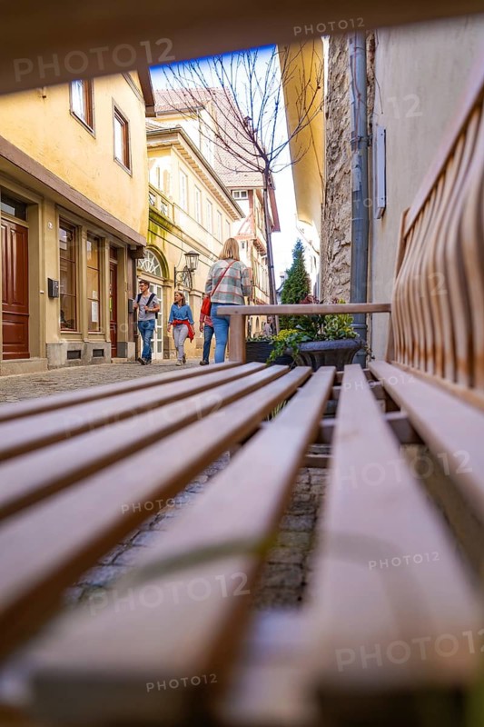Perspective of a bank with people on a city alleyway, Schwäbisch Hall, Germany