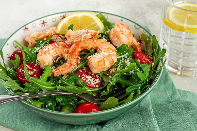 Shrimp salad with arugula and cherry tomatoes, with parmesan cheese, healthy food