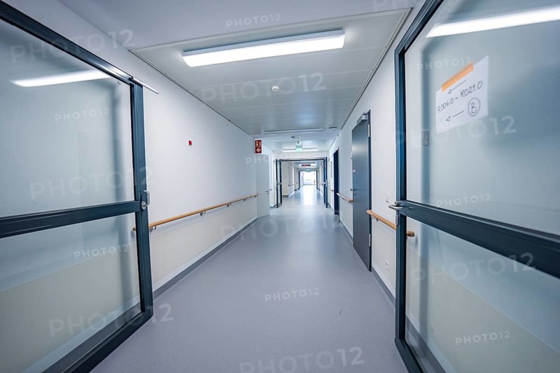Bright corridor with double glass doors, modern interior in blue and white colors, new Calw Hospital, Germany