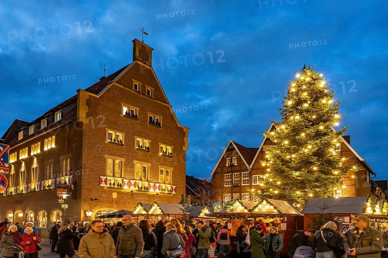Christmas market or Christmas village at the Kiepenkerl memorial at dusk, Münster, North Rhine-Westphalia, Germany