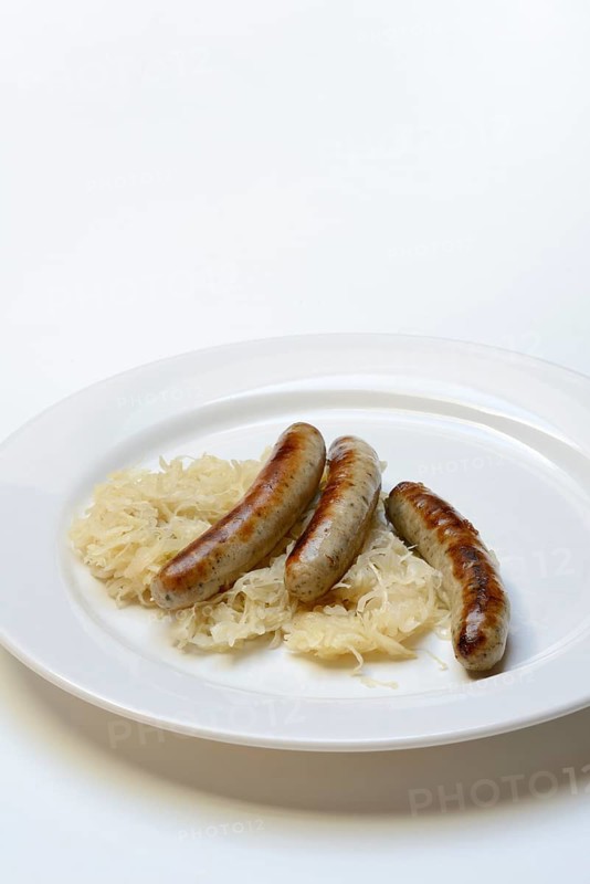 Nuremberg sausages with sauerkraut on a plate, Rostbratwurst, Germany