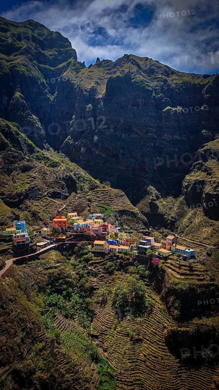 Panoramic view, small settlement, colorful village, nestled in raw, dramatic mountains under blue skies, spectacular hiking, natural heritage, cultural heritage, terraces in Fontainhas, Santo Antao, Cabo Verde, Cape Verde, Cape Verde, Cape Verde
