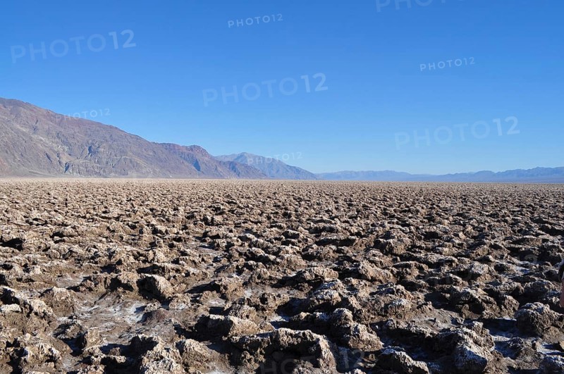 Rough, irregular salt formations in an extensive desert landscape, Devil's Golf Course, Badwater, Death Valley National Park, Mojave Desert, California, Nevada, USA
