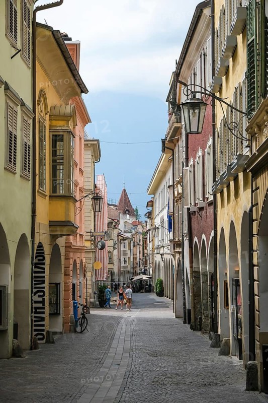 Merano, South Tyrol, Italy, A few passers-by stroll through the Laubengasse, the arcades are the heart of the old town centre
