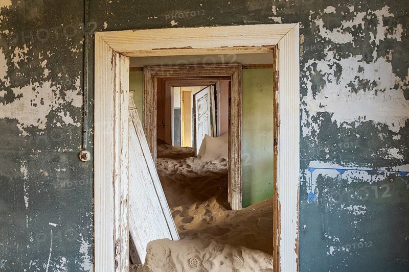 At Kolmanskop, the abandoned ghost town of the diamond days of the early 1900 and of German origin. Inside the restricted Diamond Area east of the coastal town of Lüderitz. Namib Desert, Namibia