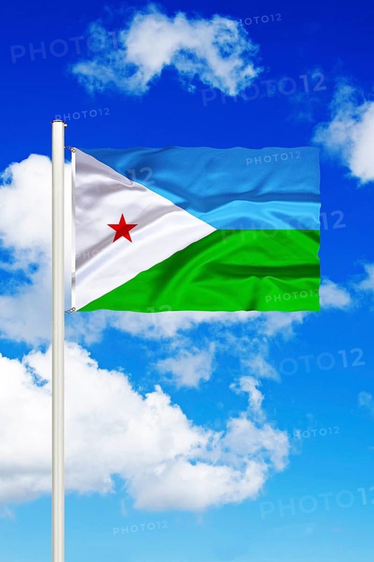 National flag of Djibouti in front of cumulus clouds and blue sky, Studio