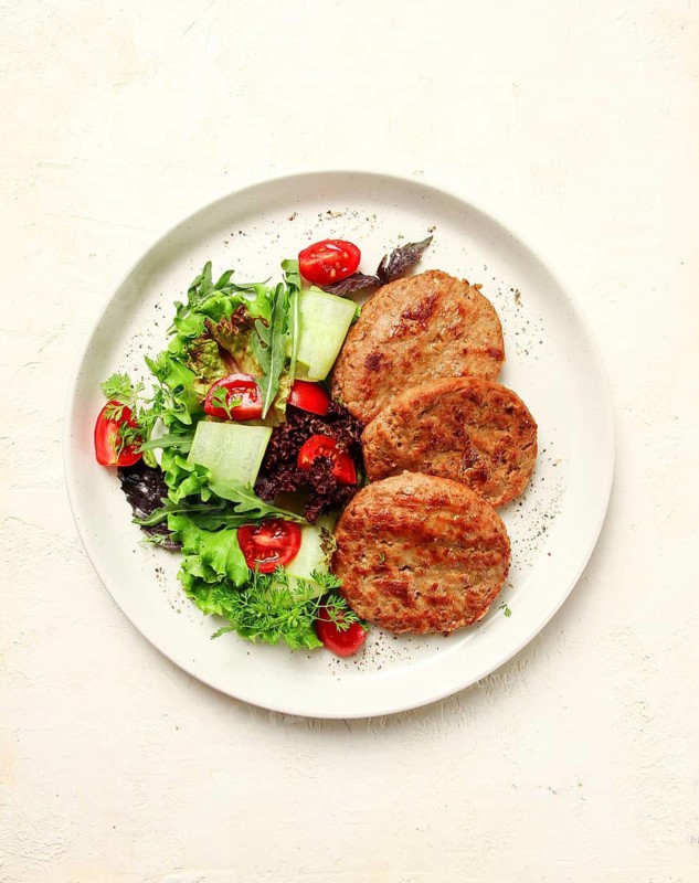 Fried cutlets, minced beef, with vegetable salad, top view, no people