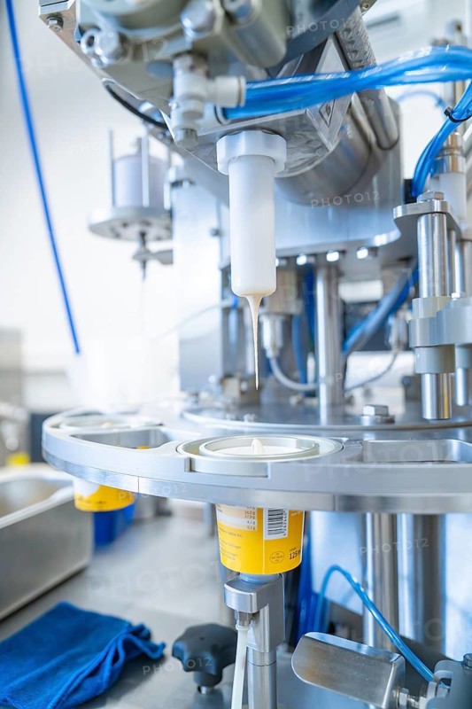 Industrial plant fills yoghurt into yellow tubs with blue tubes, ice cream production Haselstaller Hof, Calw district, Black Forest, Germany