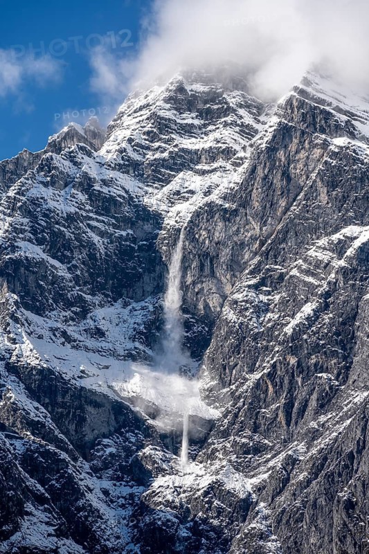 Waterfall of snow on a rock face, Watzmann east face in autumn with snow, Berchtesgaden National Park, Berchtesgadener Land, Upper Bavaria, Bavaria, Germany