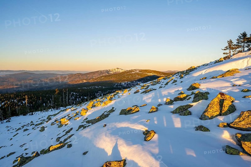 View from Mount Lusen over the hills of the bavarian forest at sunrise in winter, Bavaria, Germany