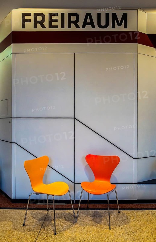 Colourful wooden chairs in the sixties style in a room in the Museum of Communication on Leipziger Straße in Berlin Mitte, Germany