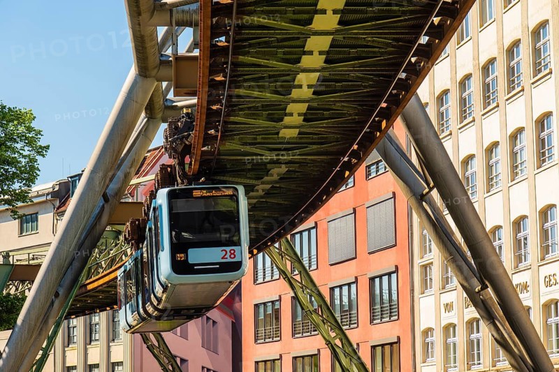 A suspension railway runs between old industrial buildings near the Kluse stop, Wuppertal, Germany