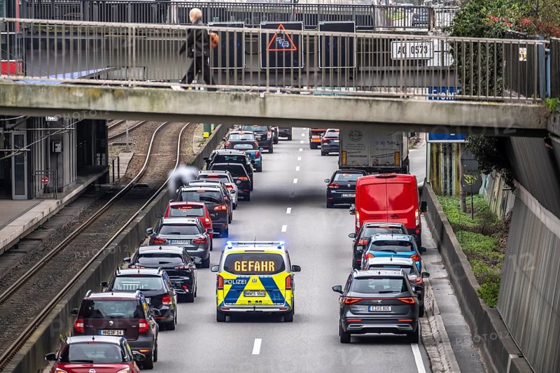 Emergency lane, police vehicle, highway police, patrol car on the way to a location on the motorway, in everyday traffic jams on the A40 motorway, Ruhrschnellweg, in Essen, a good 5 km traffic jam heading east, Dortmund, near Essen city center, narrow lanes, two-lane, high traffic volume, commuters in motorway traffic, North Rhine-Westphalia, Germany
