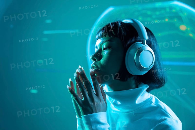 Futuristic Latin woman wears sleek headphones, absorbed in listening to music. Soft lighting and minimalistic backdrop emphasize a modern and innovative atmosphere