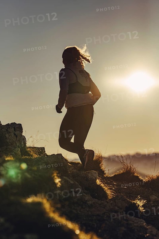 Trail running in autumn on the Jochberg on Lake Walchensee against the wonderful backdrop of the Alps, Bavaria, Germany
