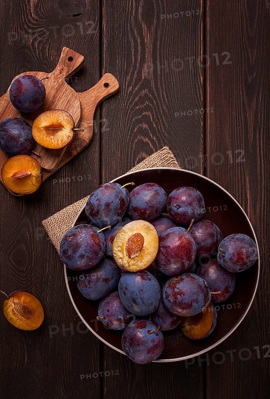Blue plum, on a wooden table, top view, close-up, no people