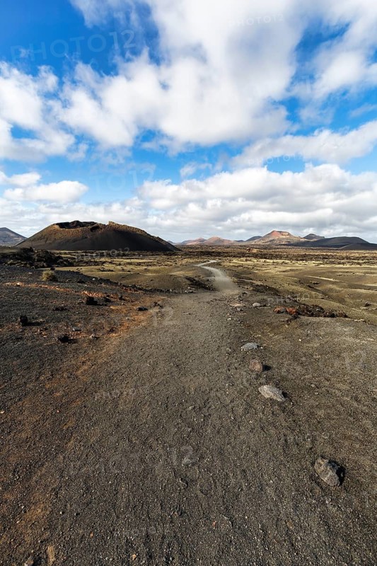 Hiking trail to the volcanic crater Caldera de Los Cuervos, lava fields, Los Volcanes nature park Park, Tias, Yaiza, Lanzarote, Spain