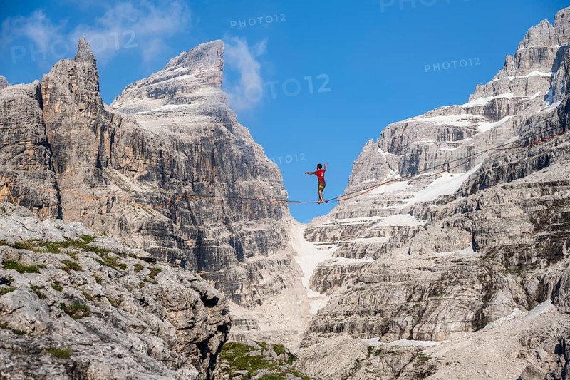 Slackliner in the mountains, mountain peaks of the Brenta Mountains, at Refugio Francis Fox Tuckett, Brenta, Brenta-Adamello Natural Park, Trentino, Italy