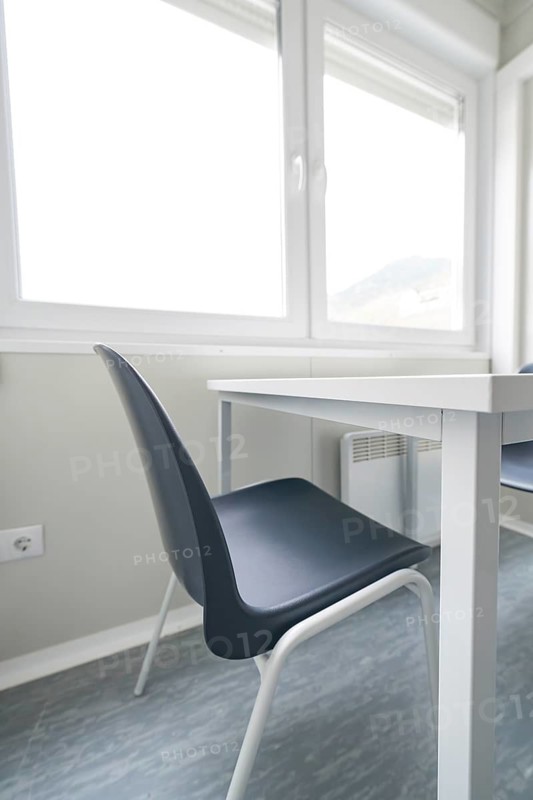 Bright room with a simple table and chair, window in the background, refugee accommodation Beermiß, Calmbach, Black Forest, Germany