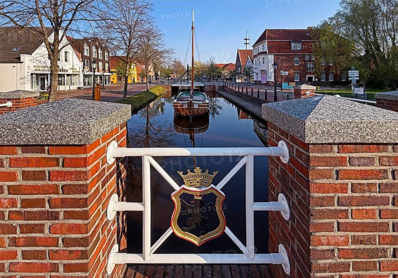 City coat of arms with open-air shipping museum on the main canal, museum ship Frisian Tjalk Thekla of Papenburg, Lower Saxony, Germany