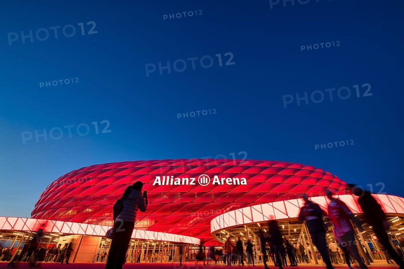 Visitors, fans, entrance area of the Allianz Arena, illuminated, overview, blue hour, in front of a Bundesliga game, Allianz Arena, Munich, Bayern, Germany