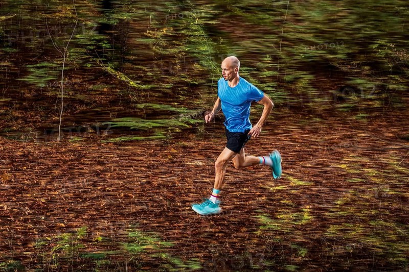 Man in a training session, trail running outdoors, healthy lifestyle, colorful autumn forest, Swabian forest, valley Remstal, Germany