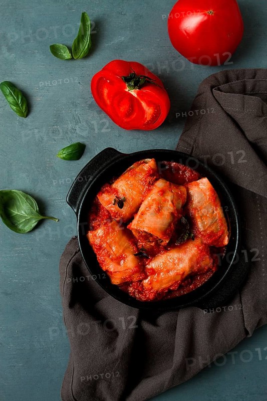 Stuffed cabbage rolls in tomato sauce stuffed cabbage leaves, minced meat with rice, on a dark background, top view, no people