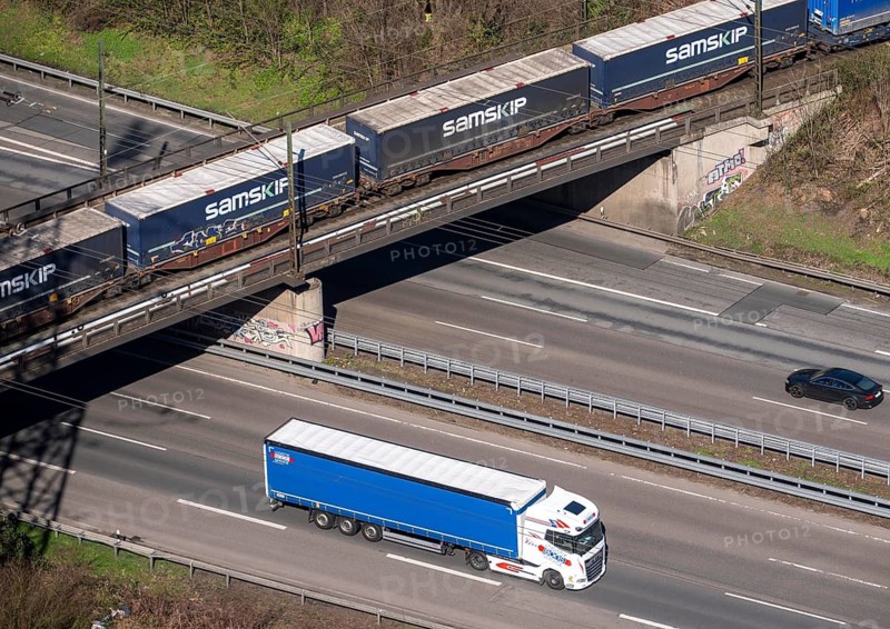 Freight train crosses the A42 motorway at Oberhausen-Zentrum on a railway bridge, the railway line comes from or goes to the OB-Osterfeld marshalling yard, busy cargo train line, North Rhine-Westphalia, Germany