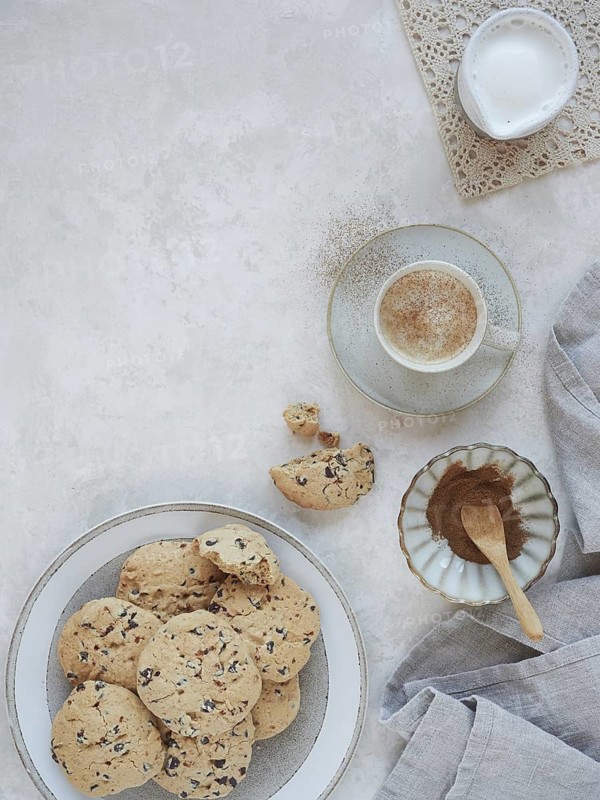 Table set with homemade cookies and hot cinnamon milk drink. Top view with copy space