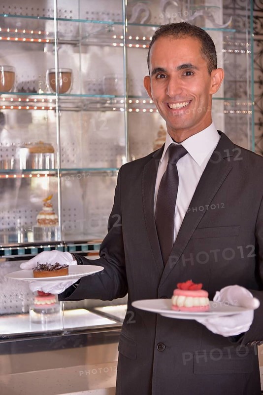 Waiter serving pastry at the Royal Mansour Hotel, Marrakesh, Marrakesh-Tensift-El Haouz region, Morocco