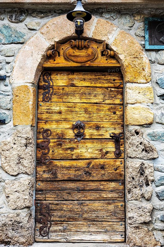 Old decorated wooden entrance door, historic village centre, Grimentz, Val d'Anniviers, Valais Alps, Canton Valais, Switzerland