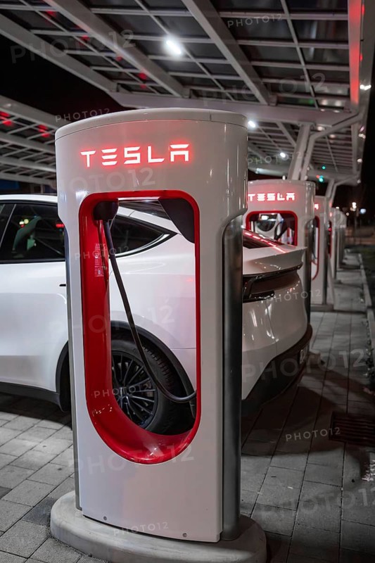 A Tesla electric car is charged at night at a charging station, Tesla, Leonberg, Germany