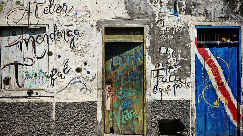 Atelier mendinga Tarrafal, colorful wall paintings and lettering on weathered wall with two colorful painted doors, Ribeira Grande, Santo Antao, Cabo Verde, Cape Verde, Cape Verde