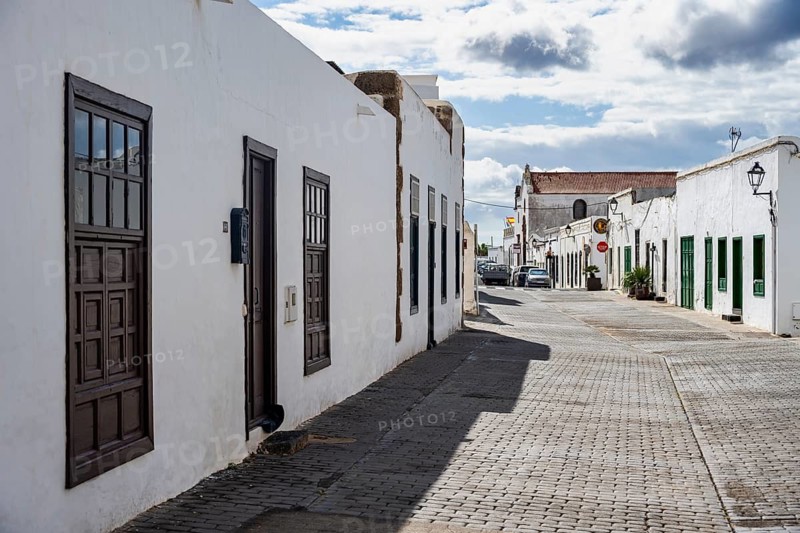 Typical white houses with colored doors and windows in an alley, Teguise, Lanzarote, Canary Islands, Spain