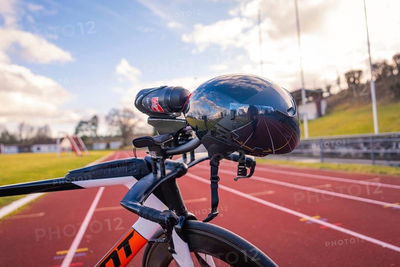 Futuristic bicycle helmet on a running track with blue sky and reflection, triathlon bike, Calw, Germany