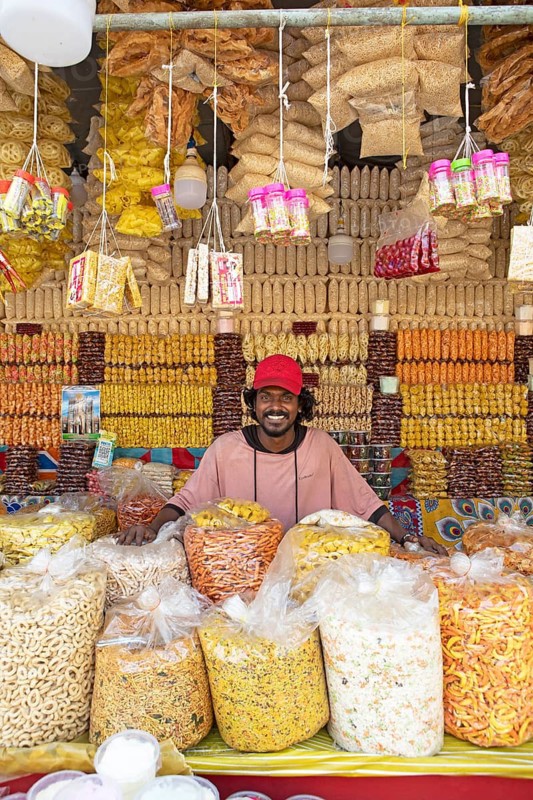 Indian man, 20 years old, selling traditional rice snacks, Arthunkal, Kerala, India