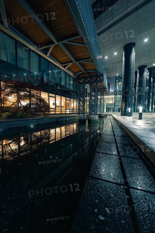Modern architecture with water reflection and lights at night, Stuttgart, Germany
