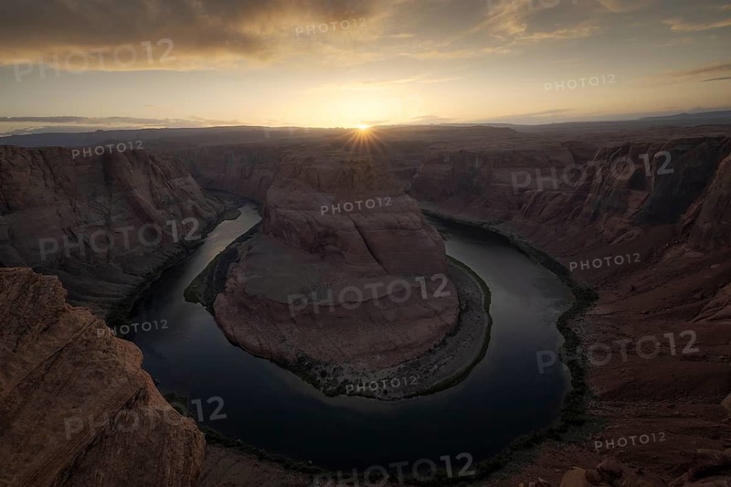 Aerial view of Horseshoe Bend at sunrise, capturing the stunning curves of the river surrounded by the majestic rock formations, highlighting the natural beauty of this iconic site