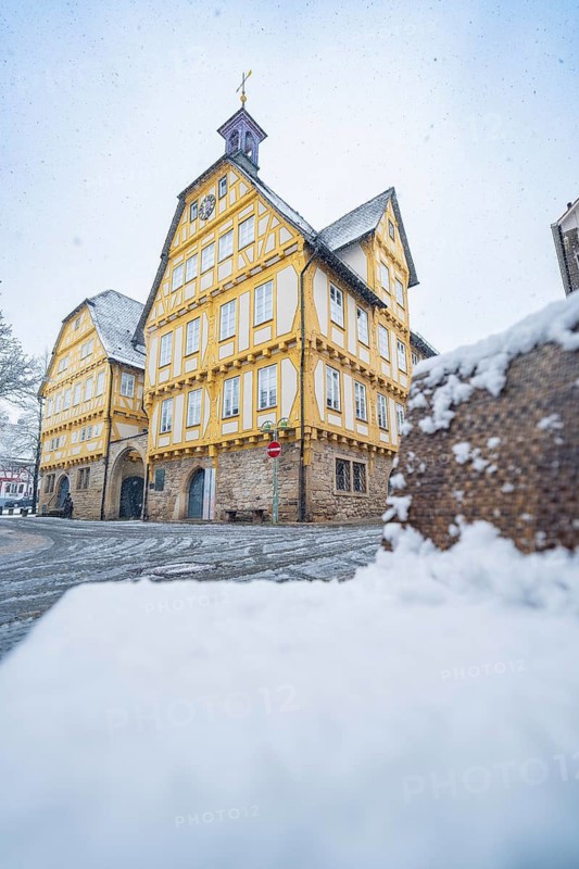 Old Town Hall, Snow-covered half-timbered house with yellow accents and historical flair in winter, Sindelfingen, Germany