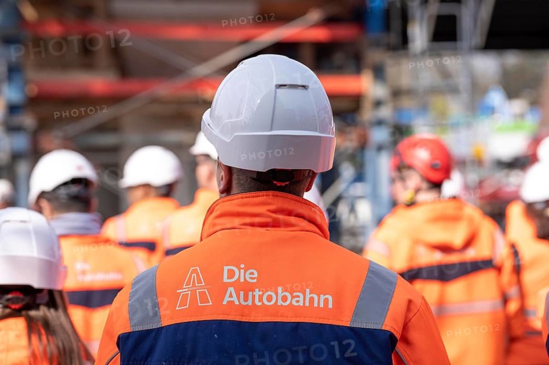 Autobahn GmbH employees wearing glowing protective clothing and safety helmet, on a construction site on the A516 motorway, Oberhausen, North Rhine-Westphalia, Germany
