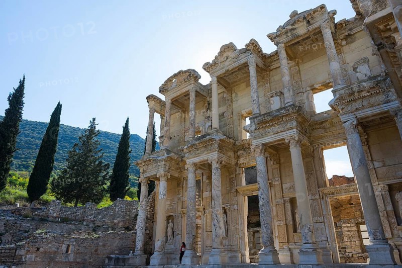 Impressive ancient façade with gigantic columns surrounded by cypresses and hills, Celsus Library, Efes, Ephesus, UNESCO World Heritage Site, Izmir Province, Ionia, Turkey