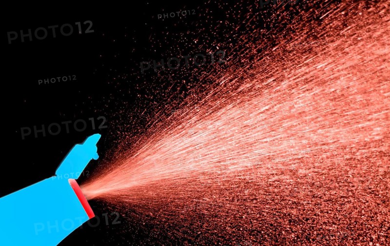 A fine spray of glass cleaner, colored against black background