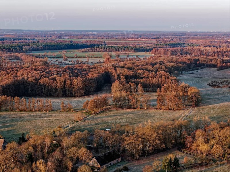 Reif lies in some fields in the countryside in the UNESCO Drömling Biosphere Reserve in the Altmark early in the morning on a cold spring day. aerial view. Dannenfeld, Gardelegen, Saxony-Anhalt, Germany