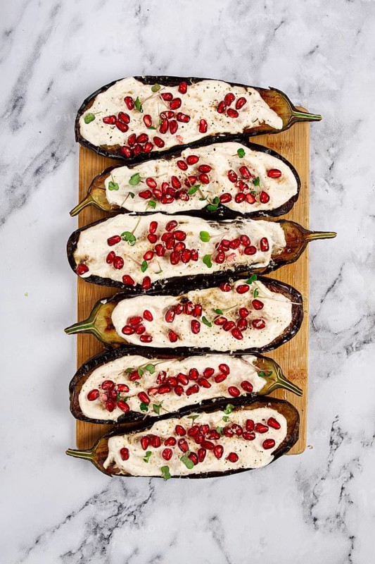 Fried eggplant with sauce, decorated with microgreens and pomegranate seeds, eggplant appetizer, top view, homemade, no people