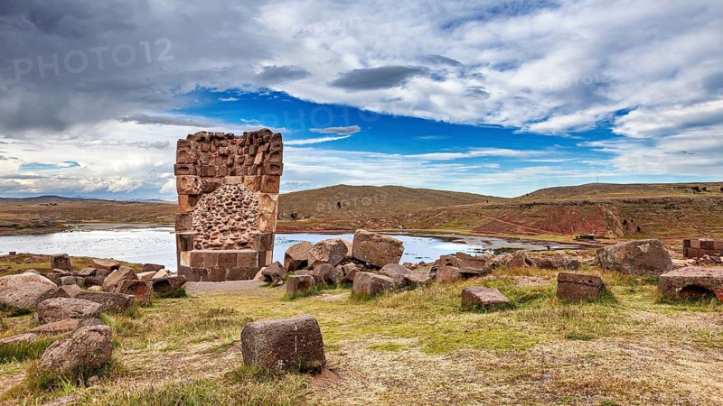 Ancient stone ruin with water and extensive landscape in the background, The Chullpas of Sillustani near Puno in Peru