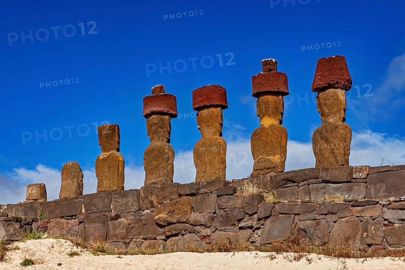Six Moai statues on a raised stone structure on a sunny day, The Moai statues on Easter Island in the Pacific Ocean