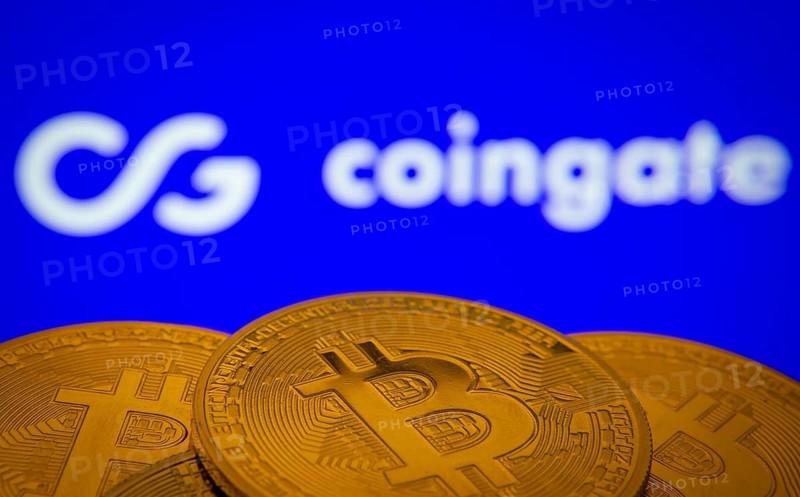 Dhaka, Bangladesh- 03 Sep 2025: Close-up of Bitcoin coins with the Coingate logo visible on a screen in the background