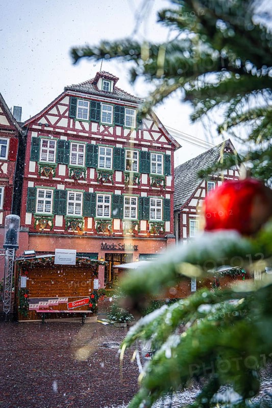 Detailed view of a decorated Christmas tree at a snowy market, Black Forest, Calw, Germany